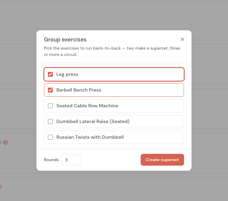 The Group exercises dialog. It reads "Pick the exercises to run back-to-back — two make a superset, three or more a circuit," lists the session's exercises as a checklist with two selected, and shows a Rounds field and a Create superset button.